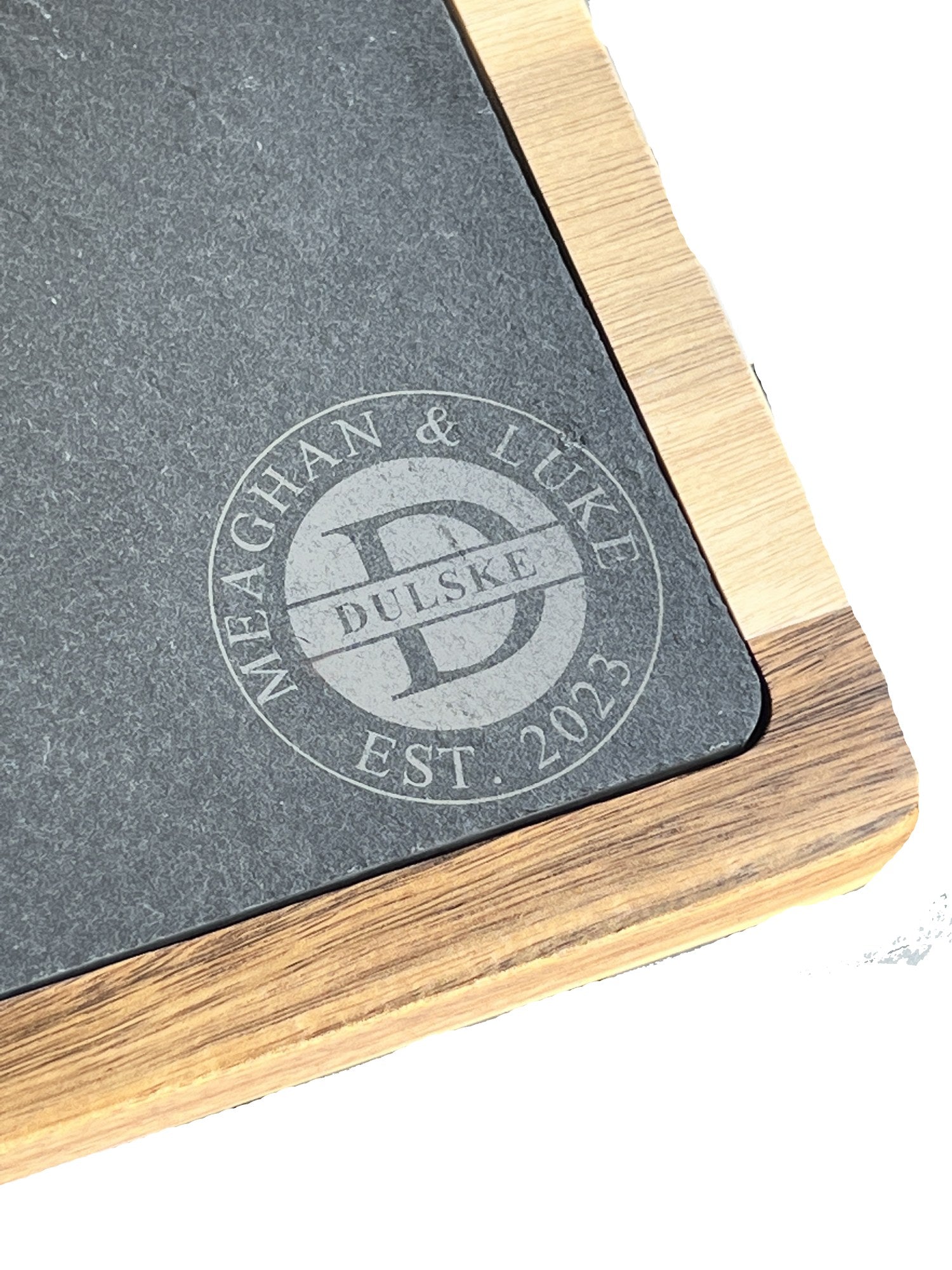 Close up of the laser engraved Dulske family monogram on the slate charcuterie board
