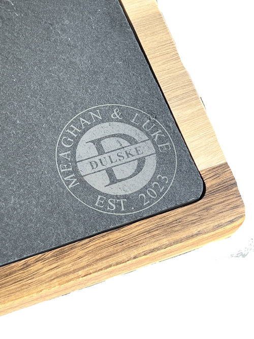 Close up of the laser engraved Dulske family monogram on the slate charcuterie board